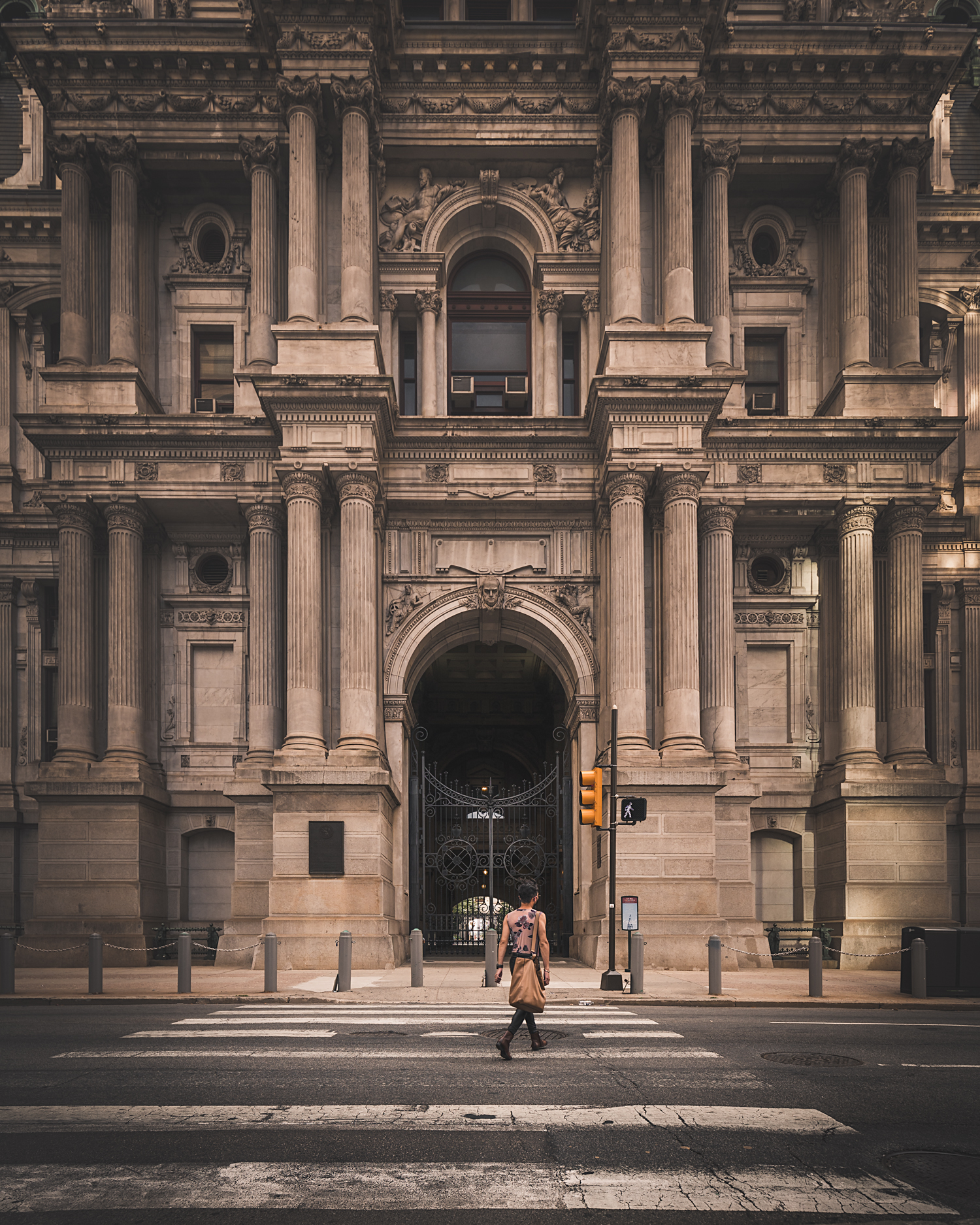 Man crossing the street in front of Philadelphia’ City Hall