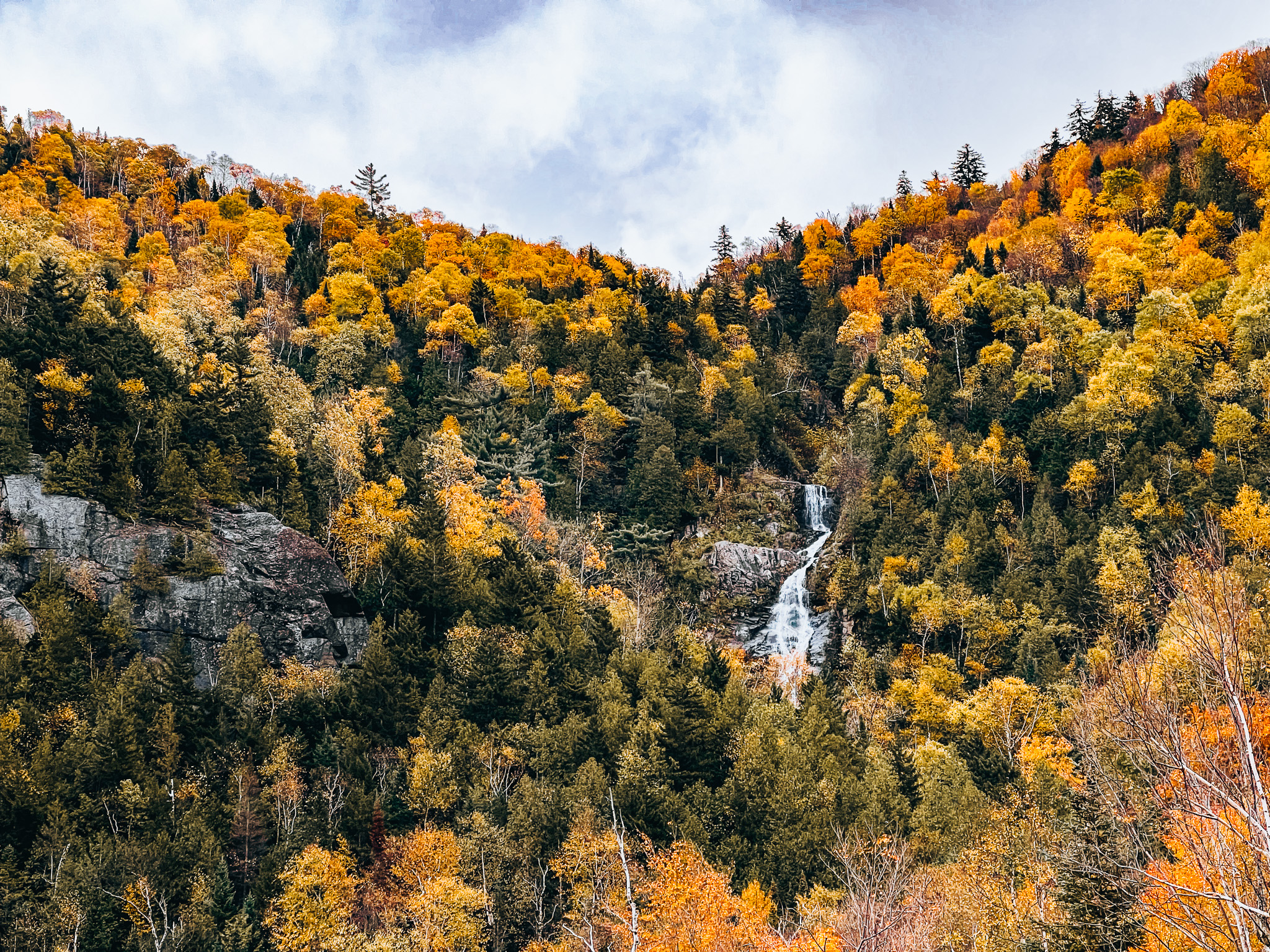 Cascade Lake waterfall among fall foliage