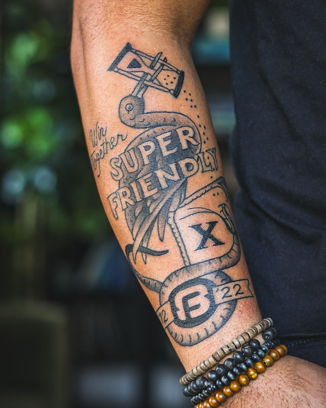 Dan Mall’s tattoo that says “SuperFriendly: Win Together. 12–22.”