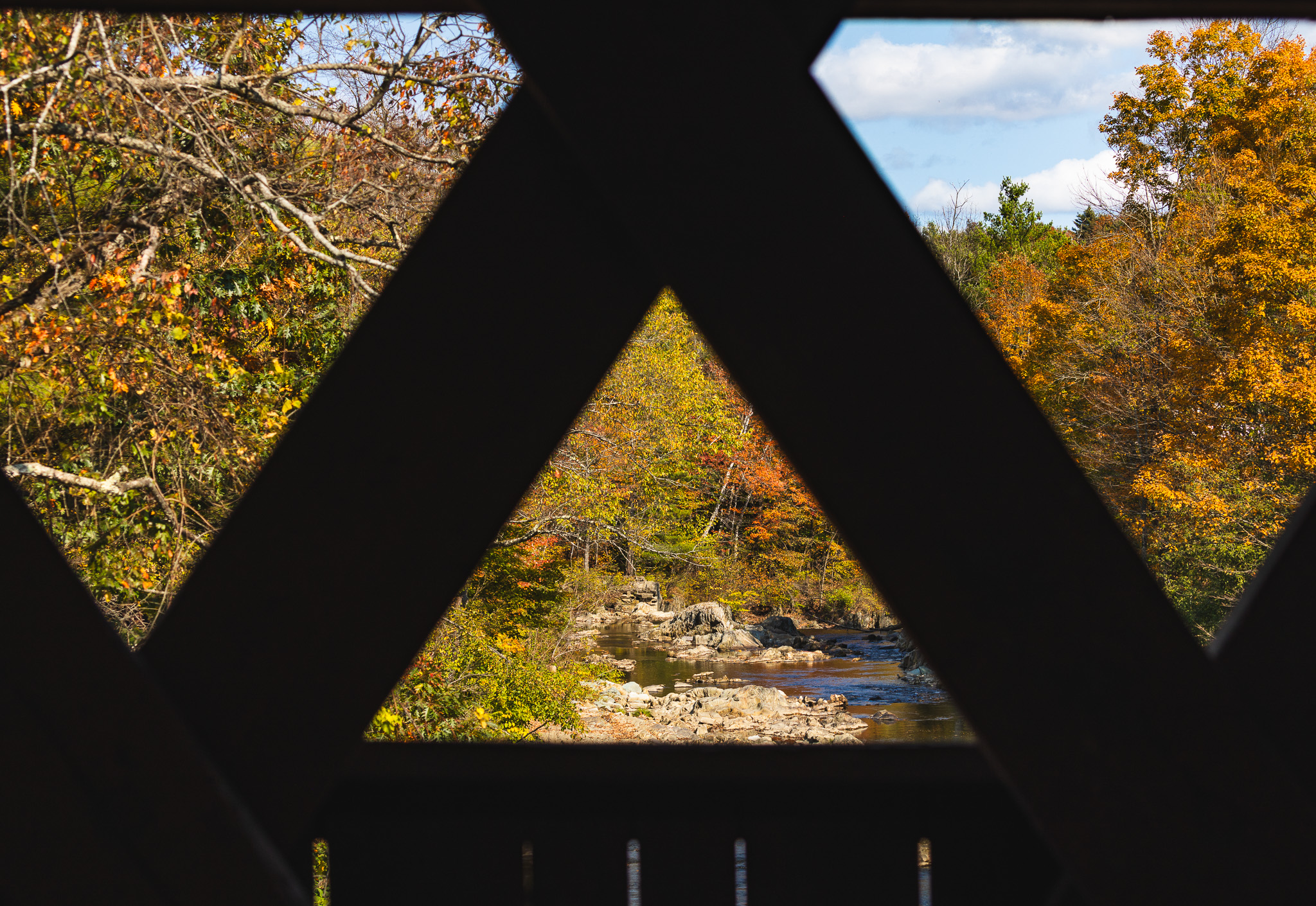 Fall landscape frame through the crossbeams of the Northfield Covered Bridge