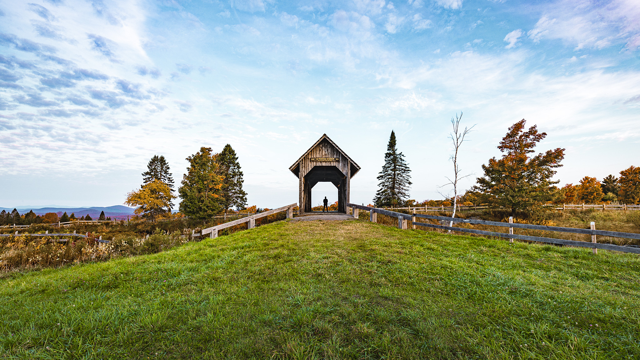 The A.M. Foster Covered Bridge with a person standing in the center of it