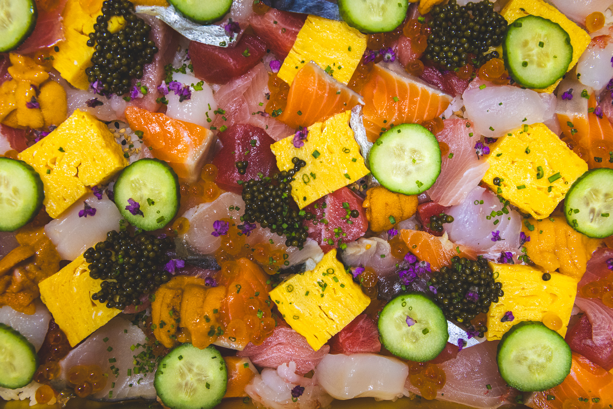 Chirashi box with tamago, caviar, fish, uni, and roe