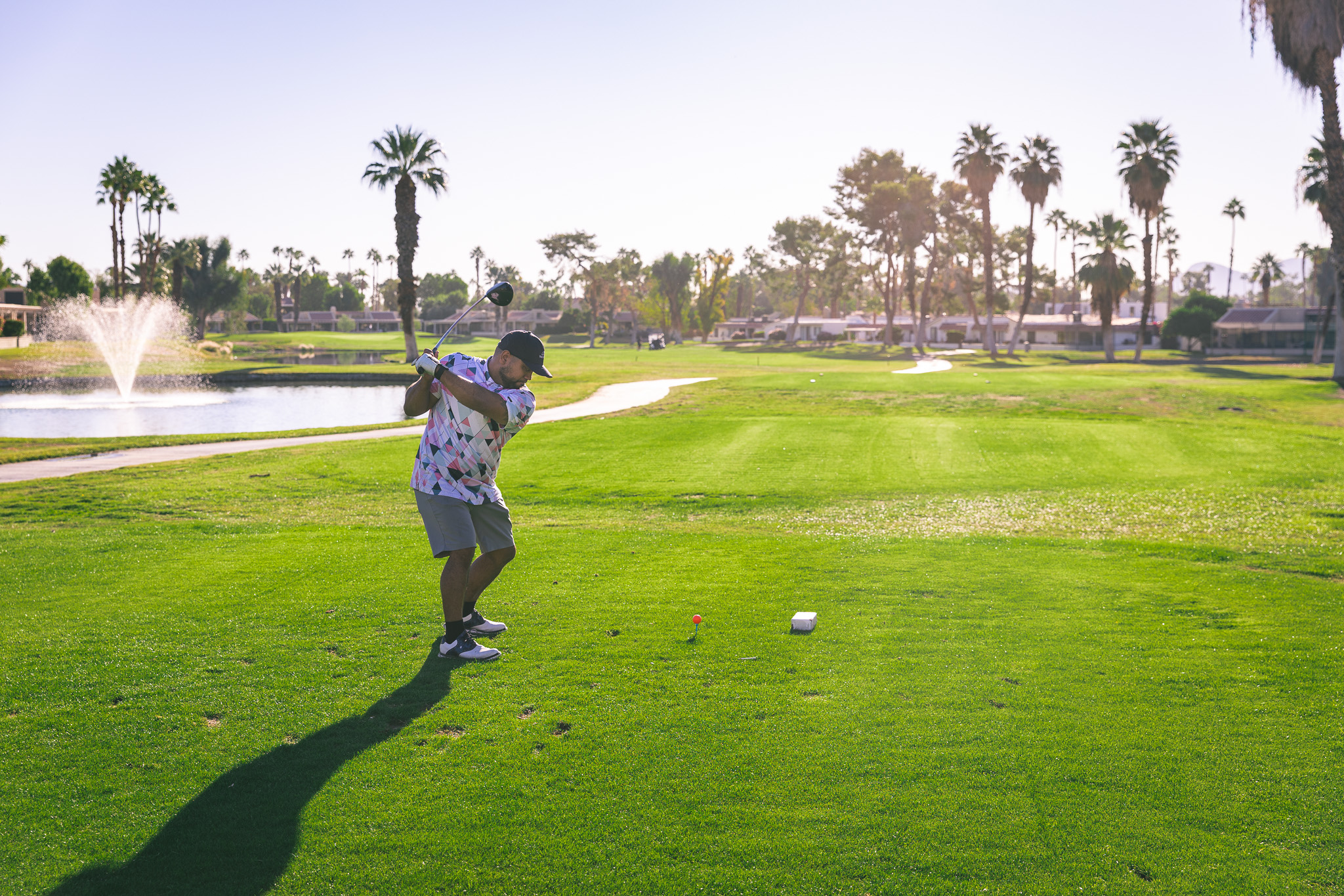 Golfer about to hit a ball on a tee