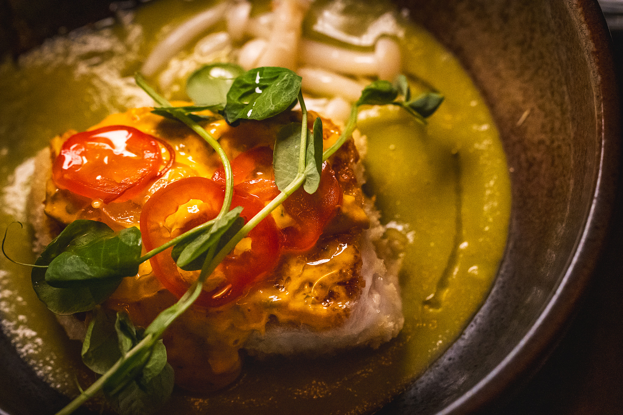 Fish in a green tomato broth