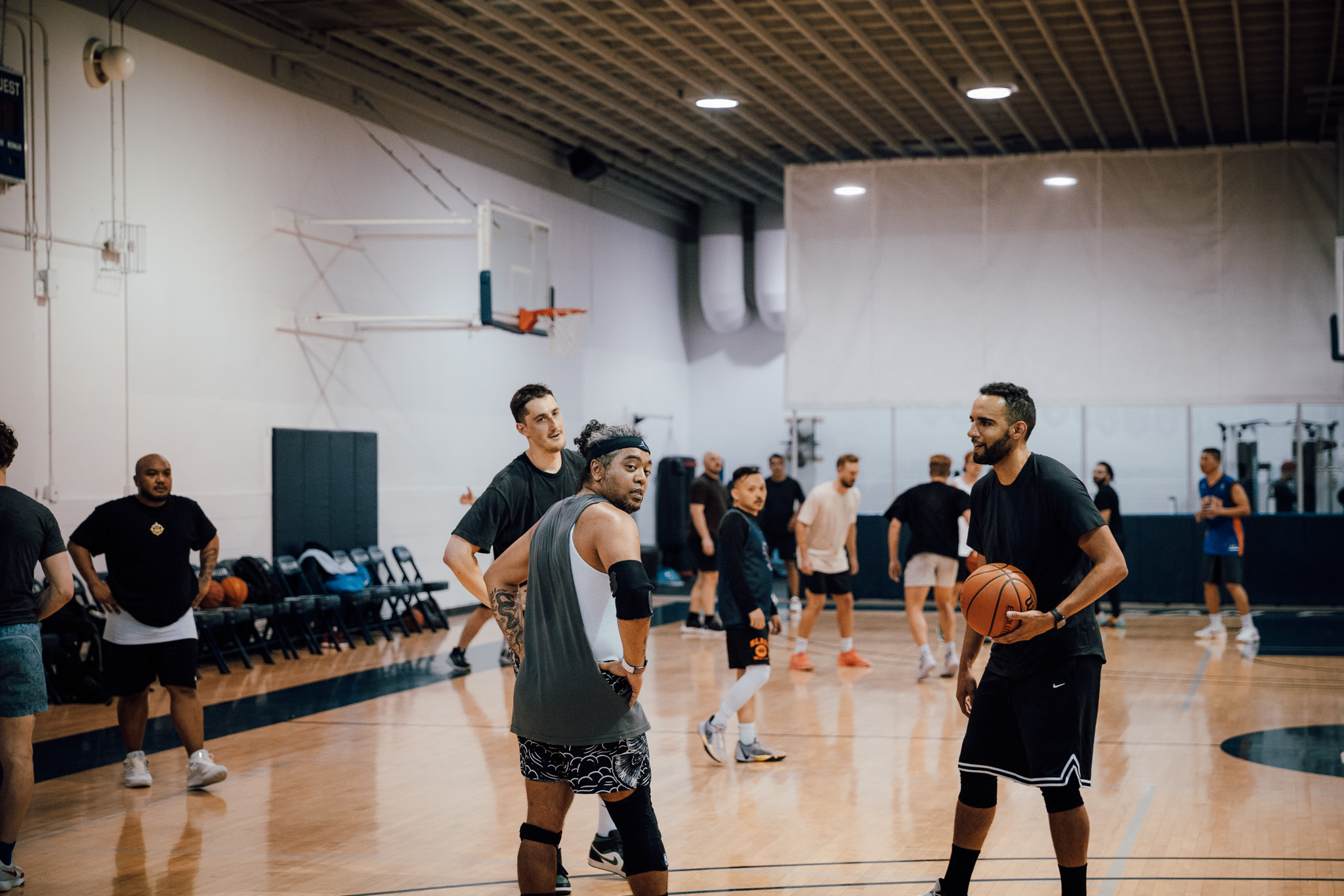 Men standing around on a basketball court