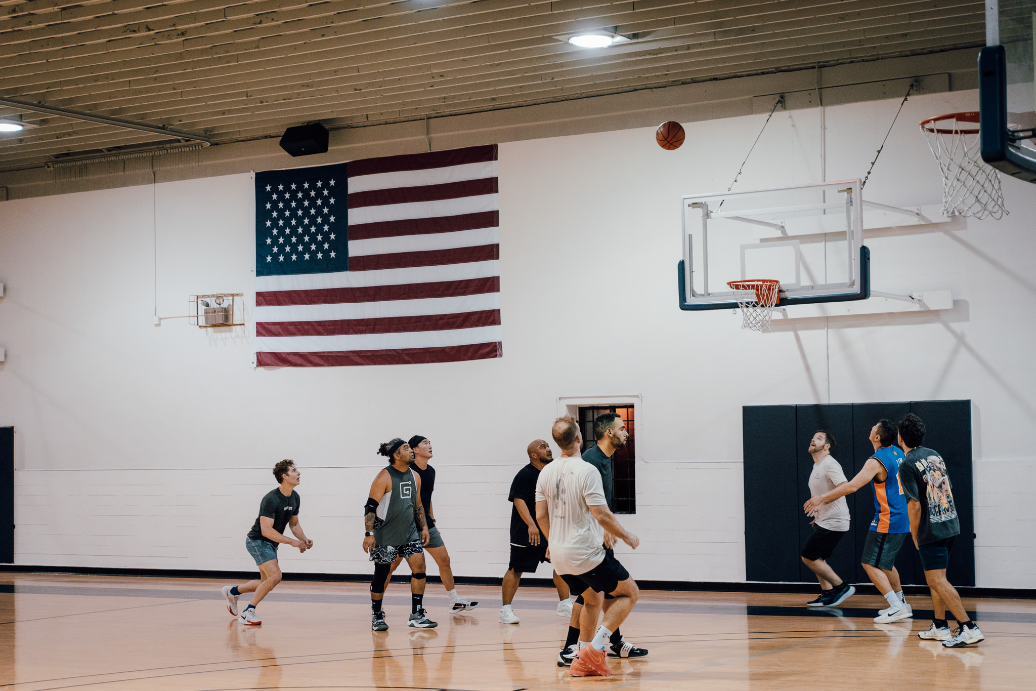 Men watching a basketball waiting for a rebound