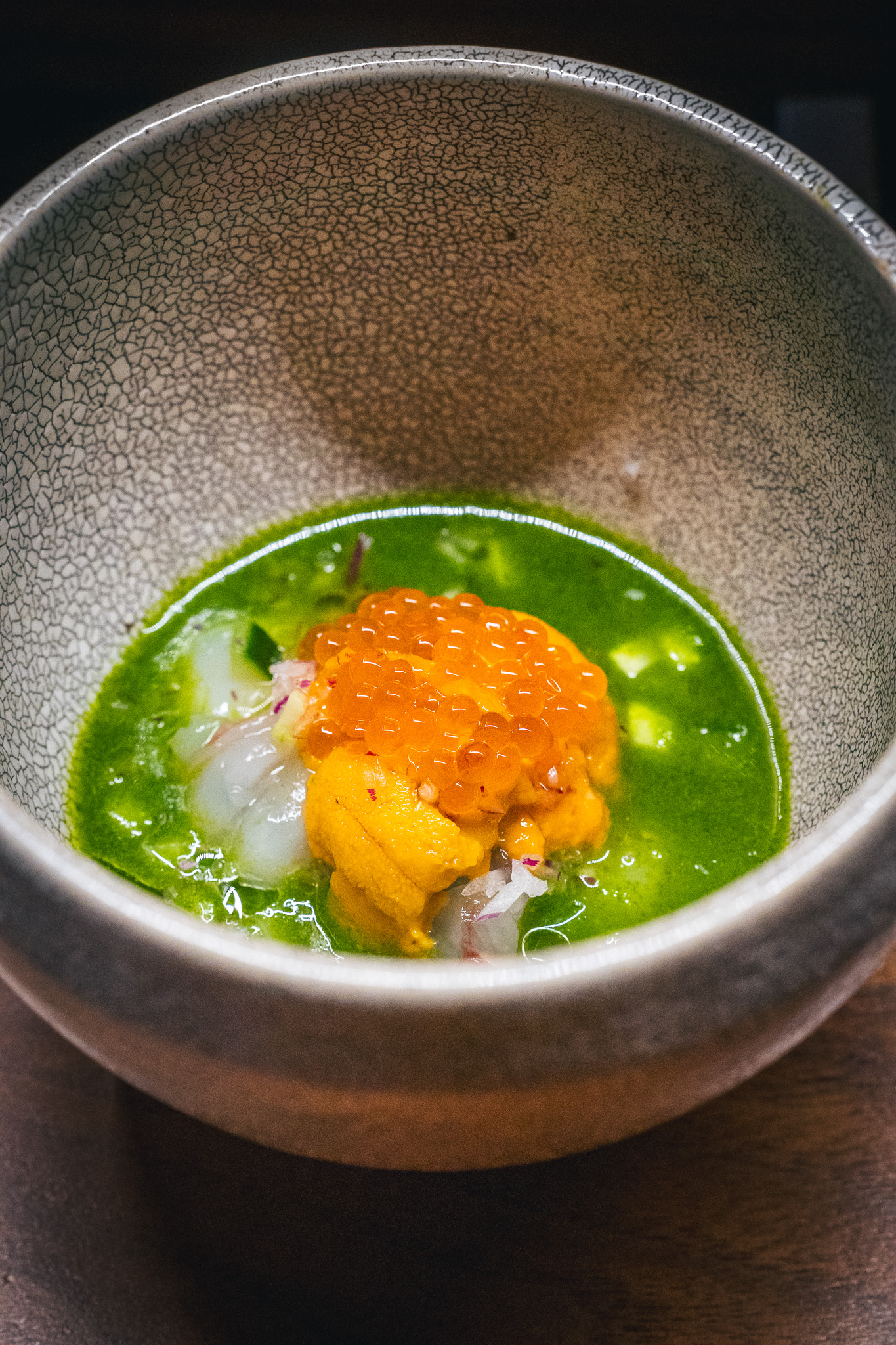 Green broth with uni and roe in a bowl
