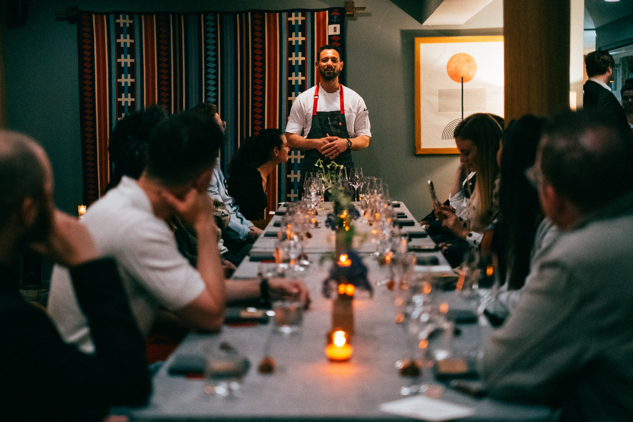 Chef addressing a long table