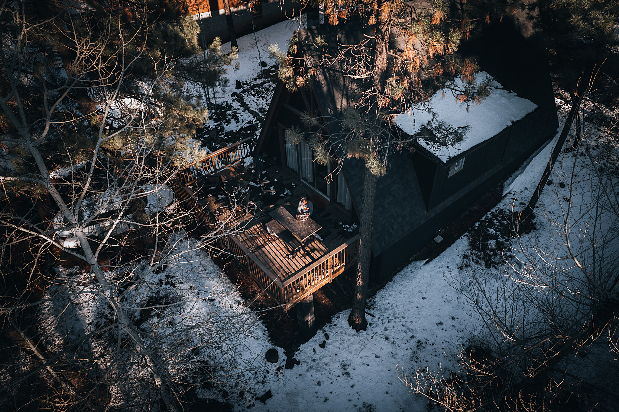 An aerial drone shot of an A-frame house