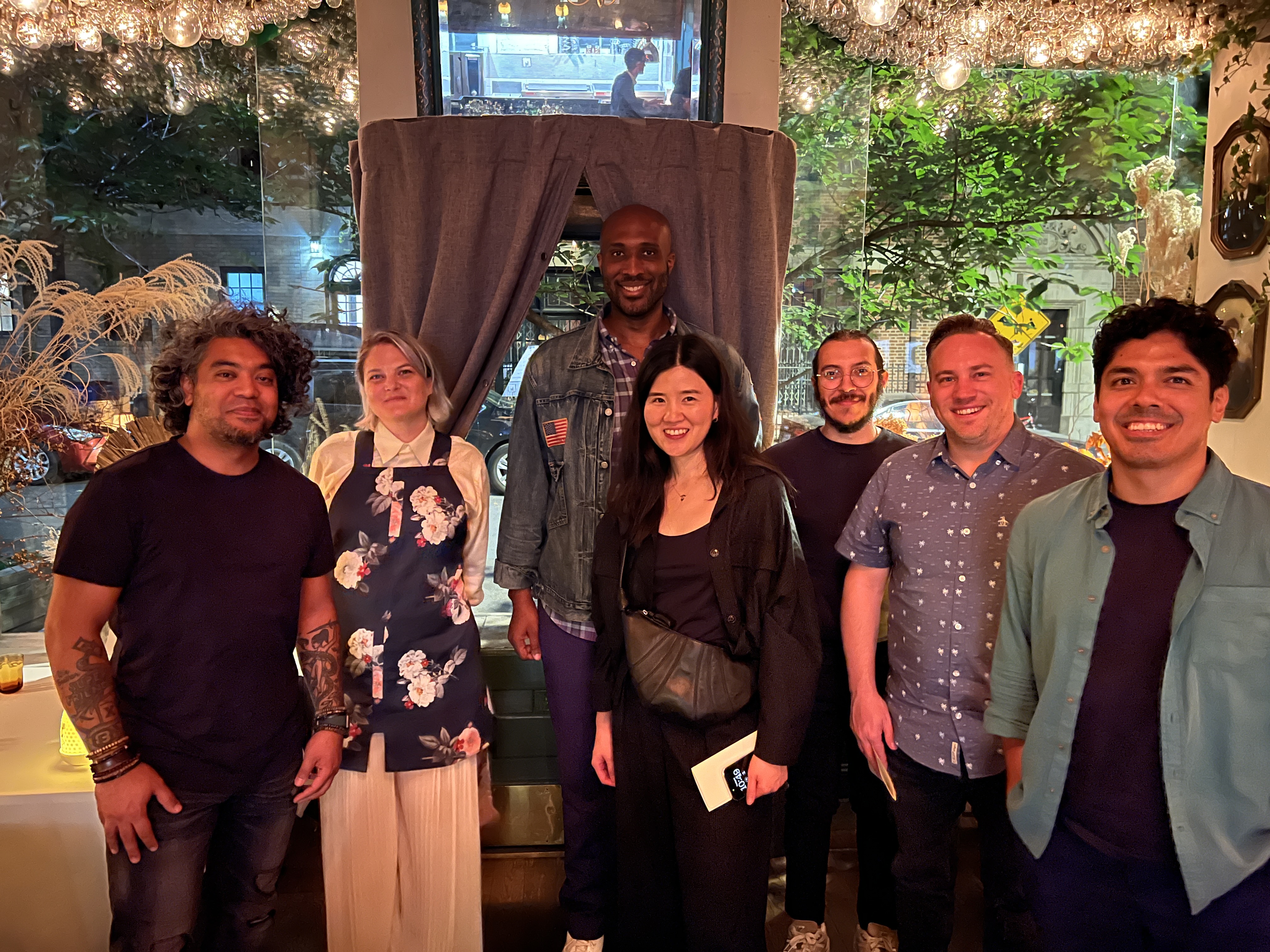 7 people posing for a photo after a Michelin Star dinner