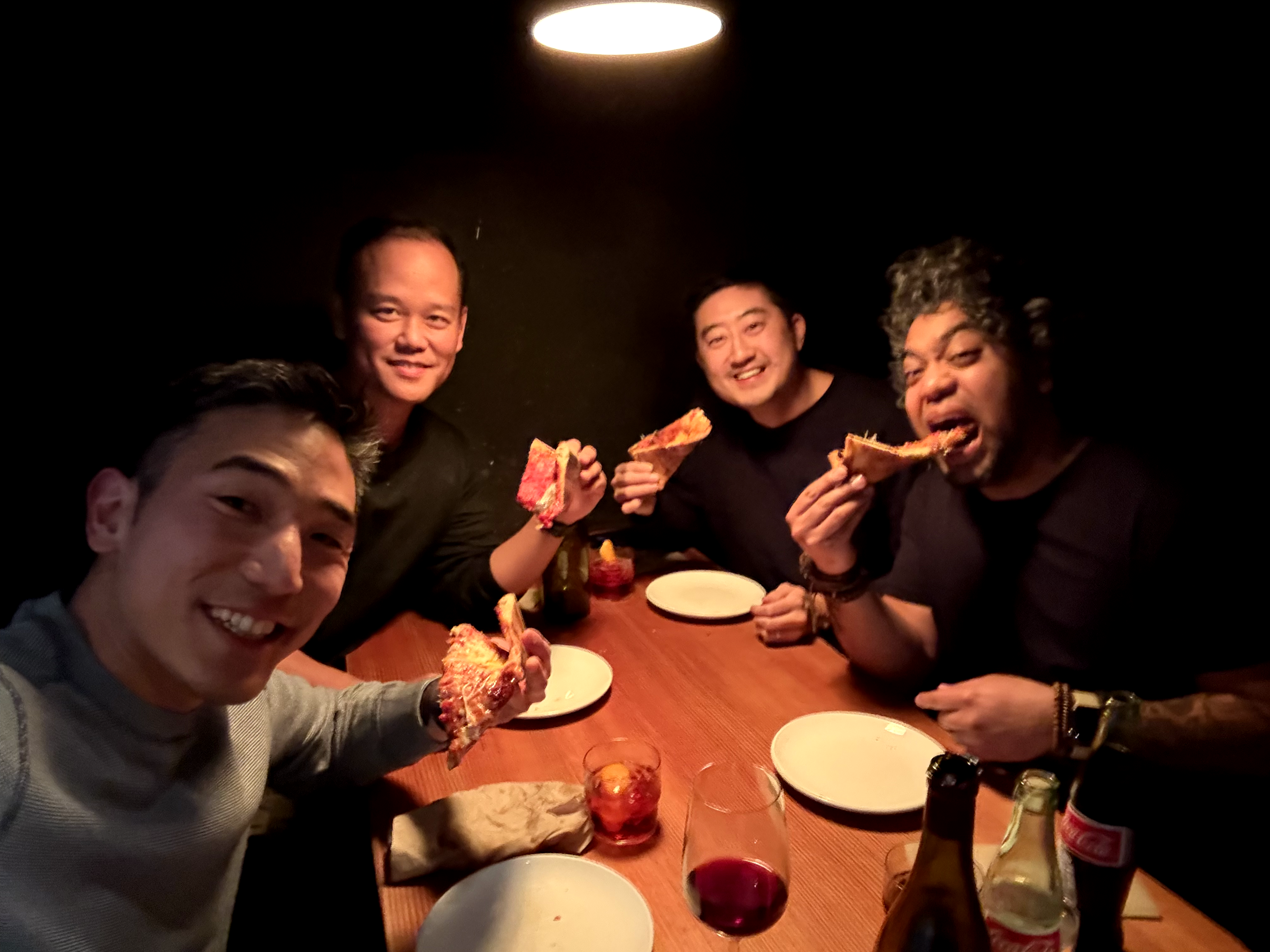 Peter Kang, Jon Sukarangsan, Sei-Wook Kim, and Dan Mall eating pizza