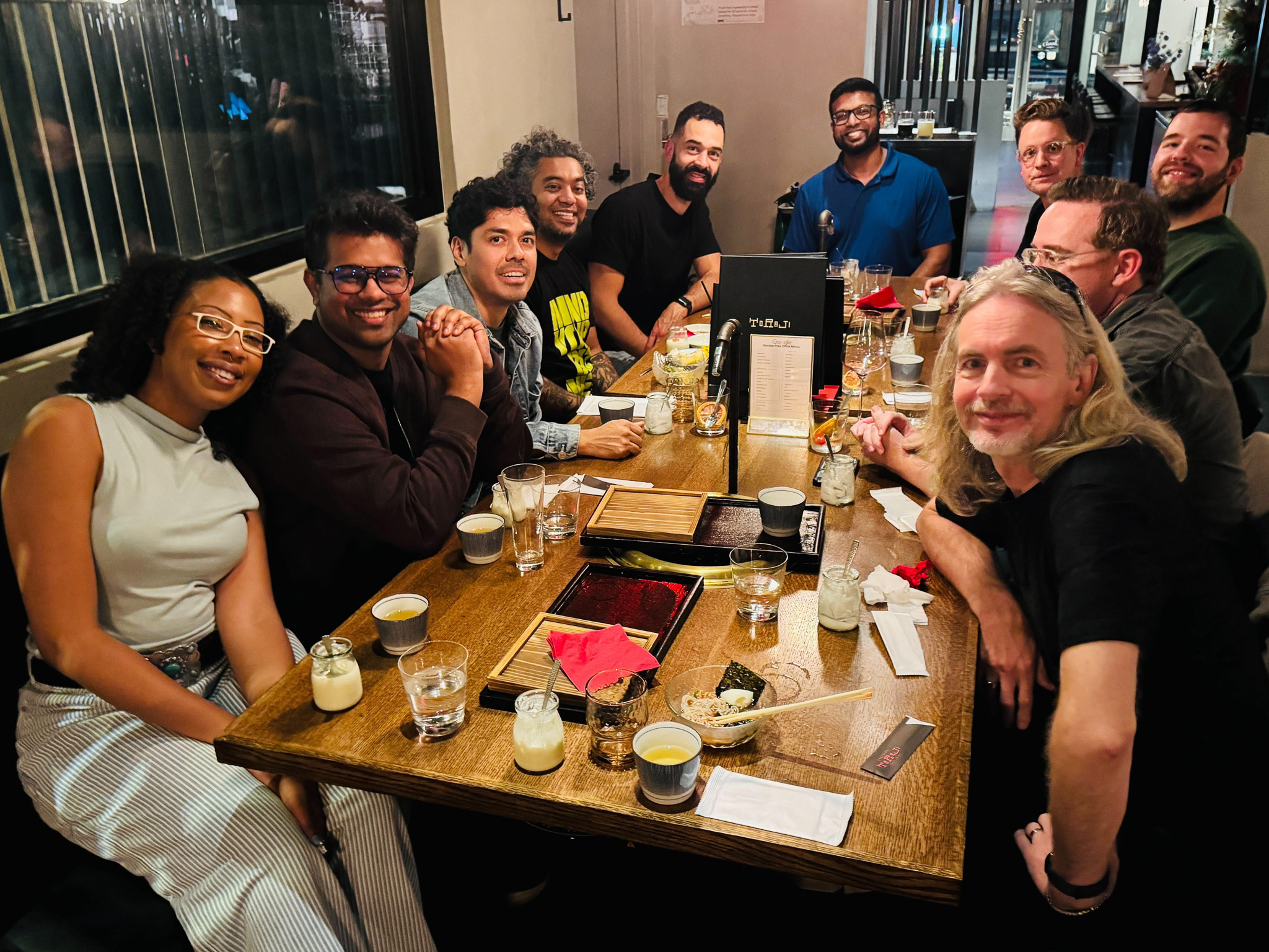 Make More Money students at a table having Korean barbecue together.