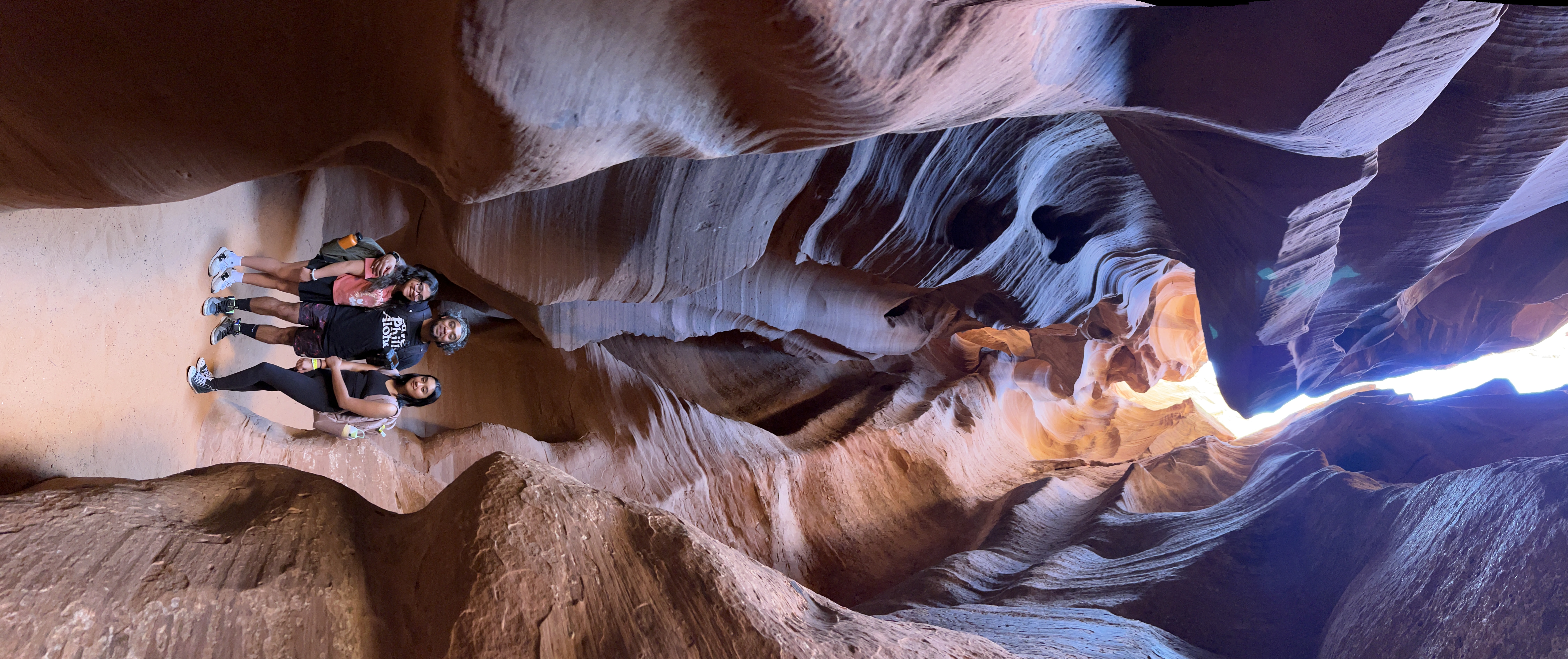 The Mall family posing in a slot canyon