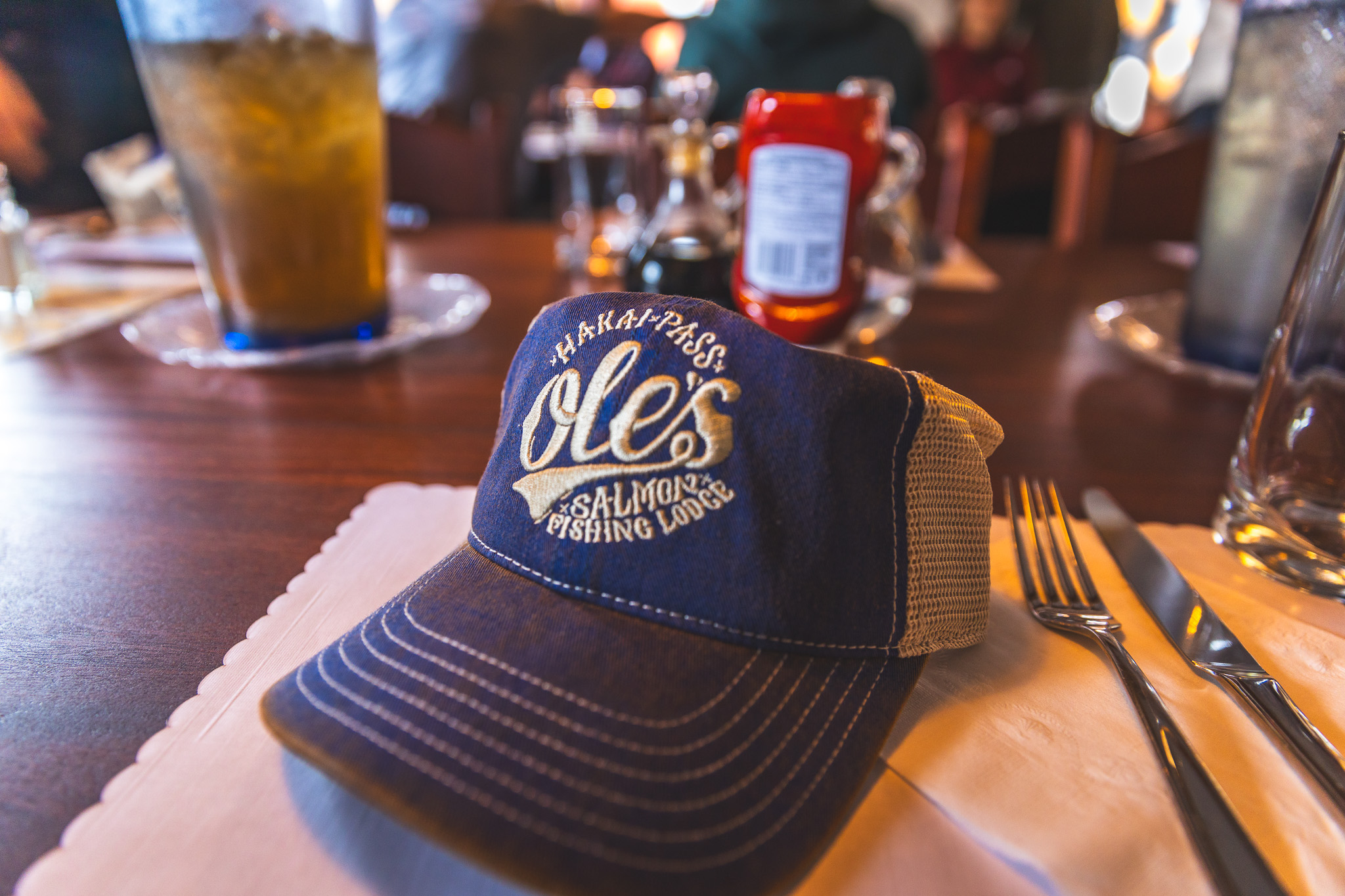 An Ole’s Salmon Fishing Lodge Hat on the table