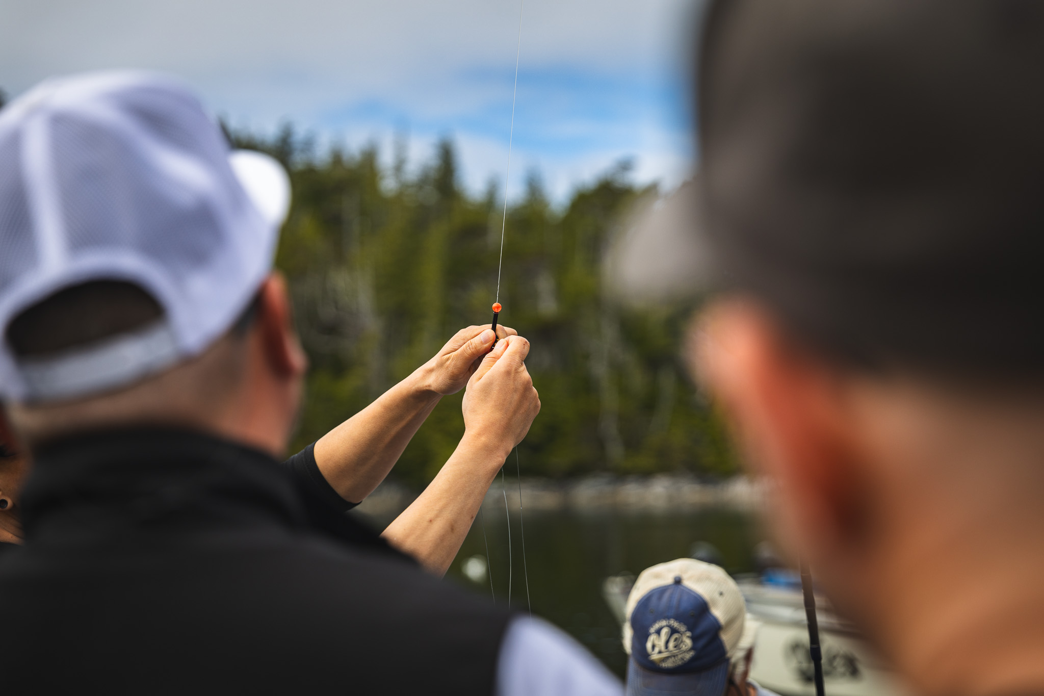 Close-up of hands tying a hook