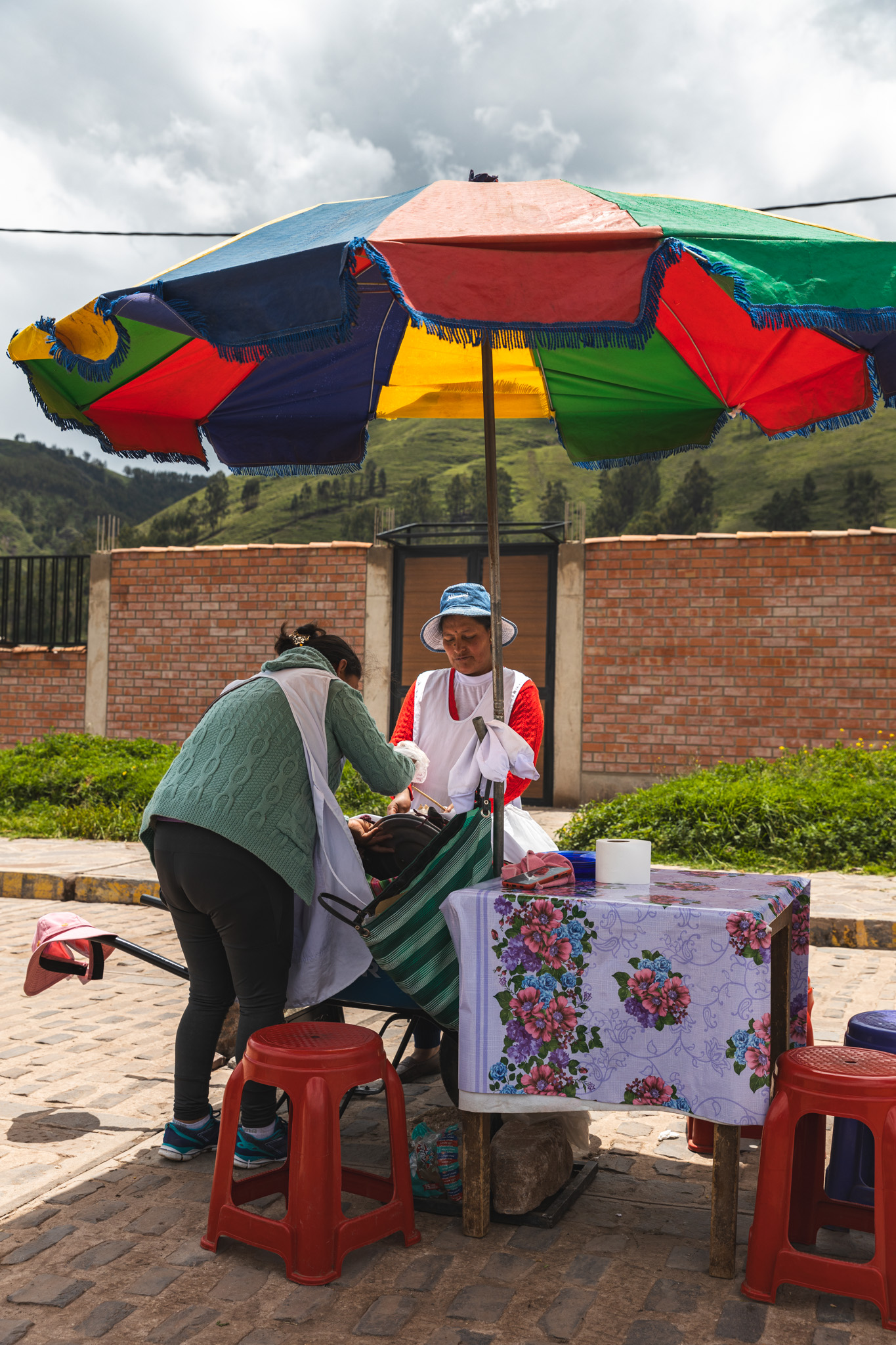 Two women on the side of the road, selling rocoto relleno